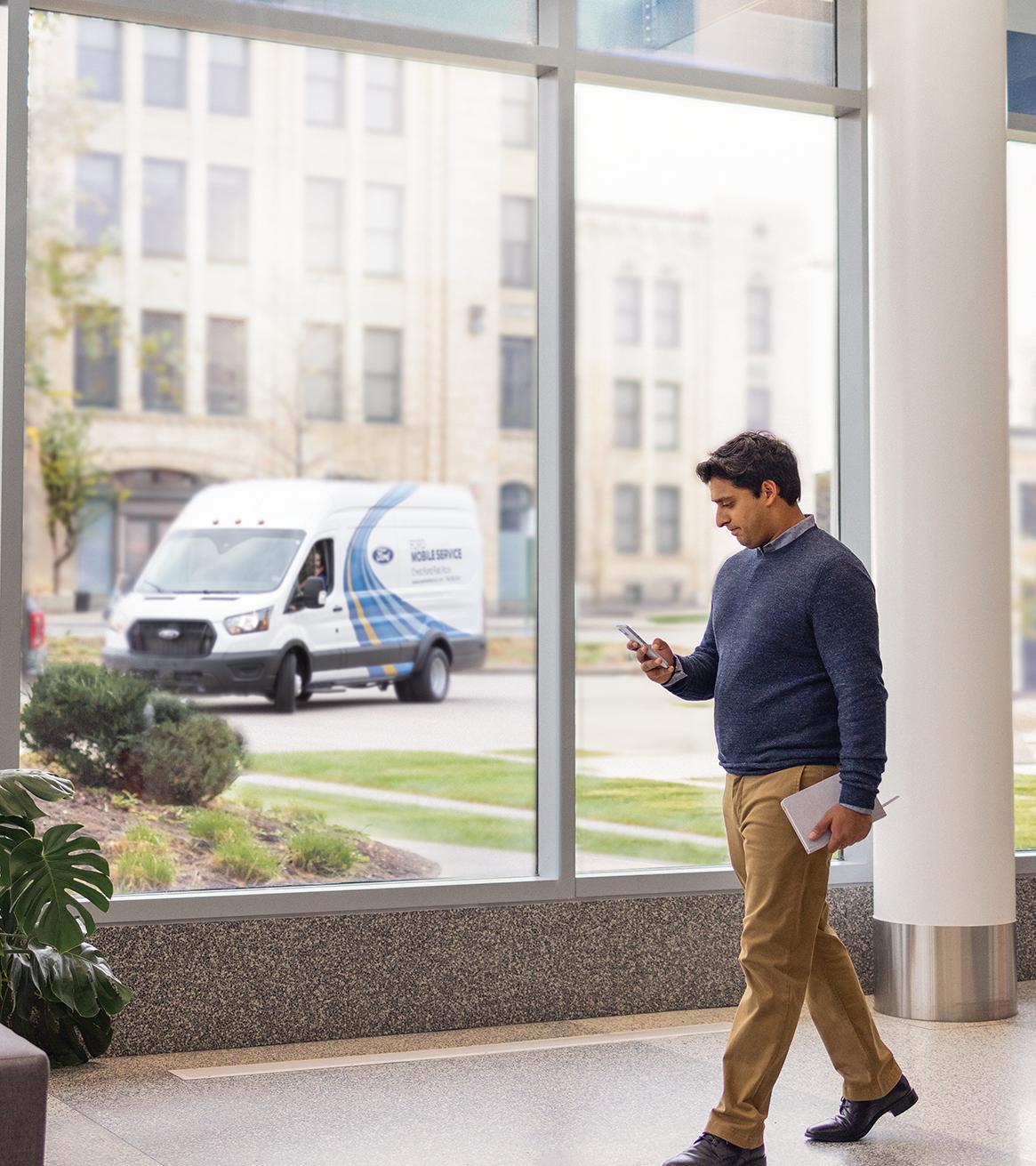 A Ford owner checks the status of their Ford Mobile Service appointment on their phone