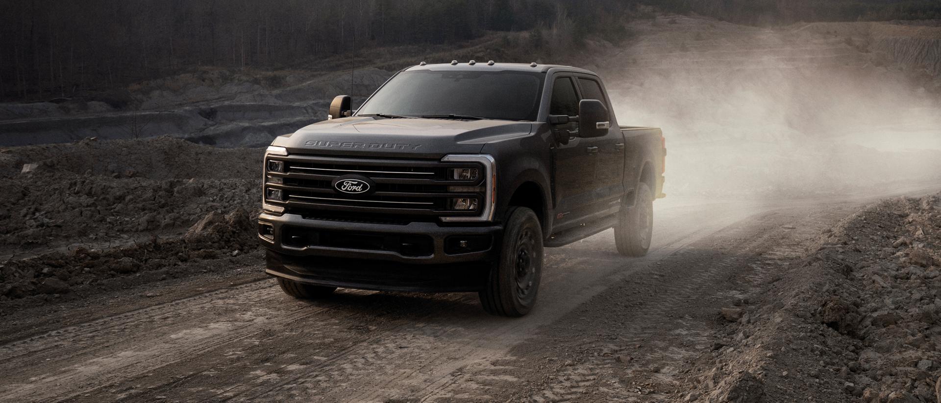 2027 Ford Super Duty® F-350® XLT model with the Super Duty Carhartt® Package being driven on a dirt road