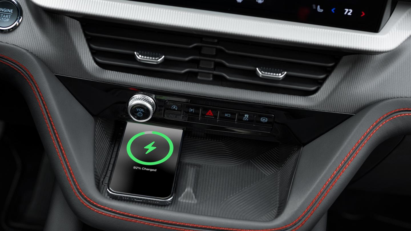 A smart phone charges on a wireless charging pad
