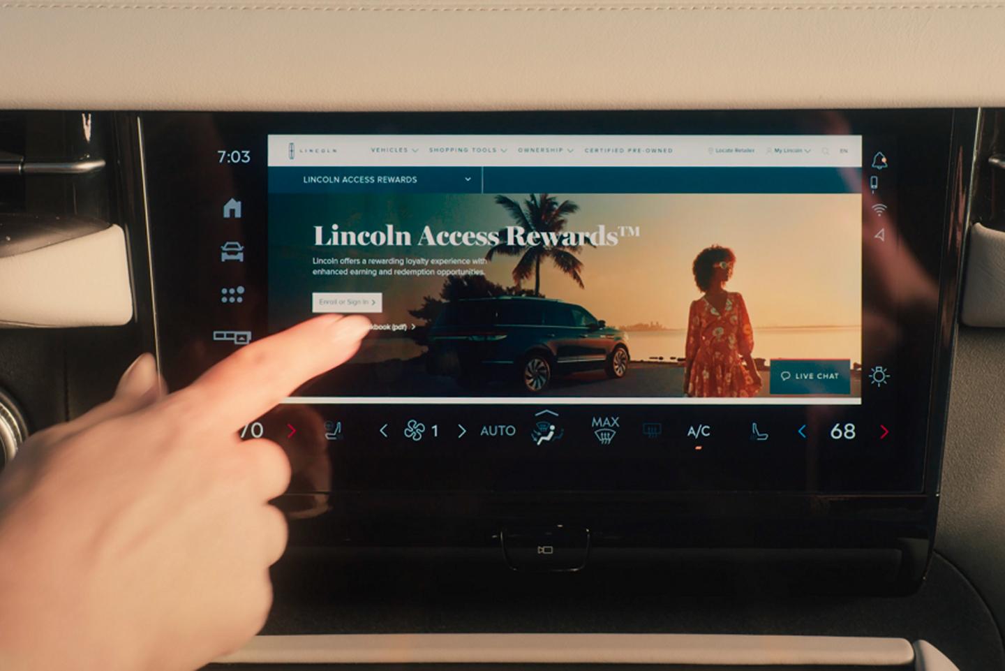 A person uses the center touch screen of a 2025 Lincoln Navigator® SUV to browse the internet