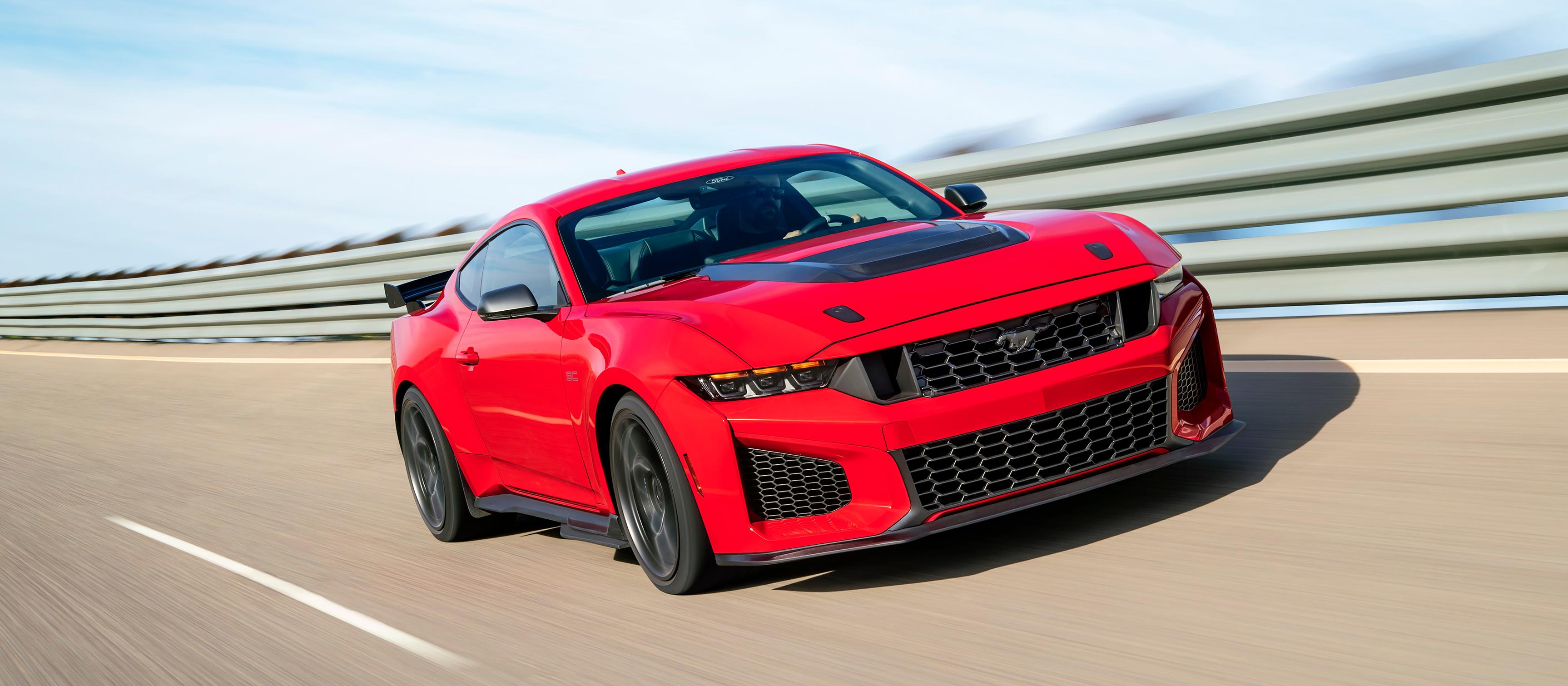 A 2026 Ford Mustang Dark Horse® SC with optional equipment driving on a closed track