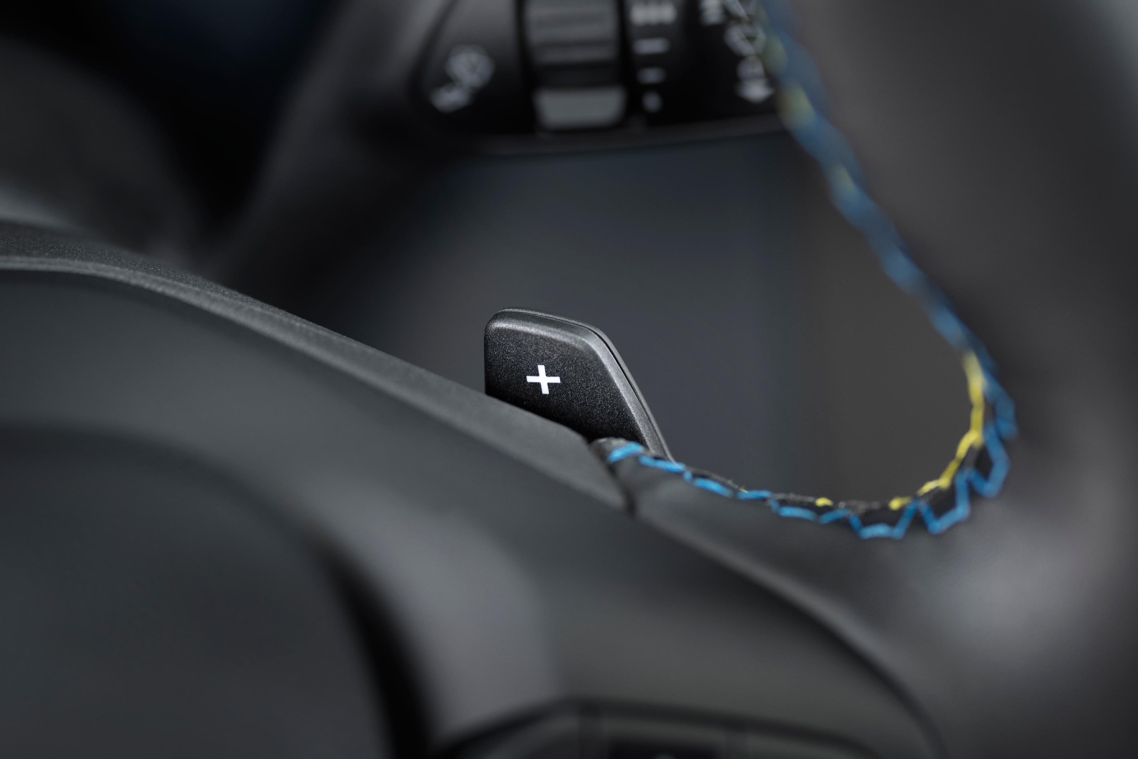 Close-up of the paddle shifter and accent stitching on the steering wheel of a 2026 Ford Maverick® Lobo™ pickup