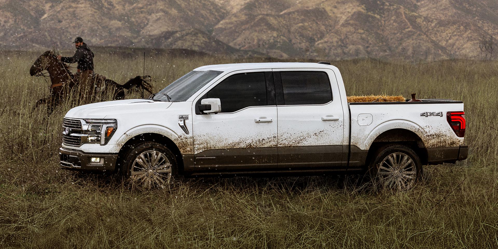 A person horseback riding next to a dirty 2025 Ford F-150® truck