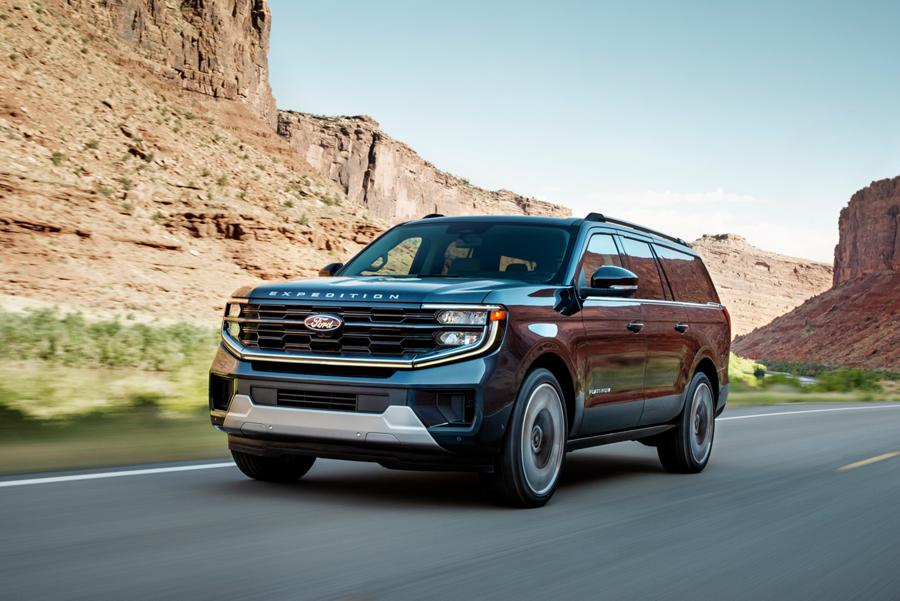 2025 Ford Expedition® Platinum MAX model driving down a mountain-lined road