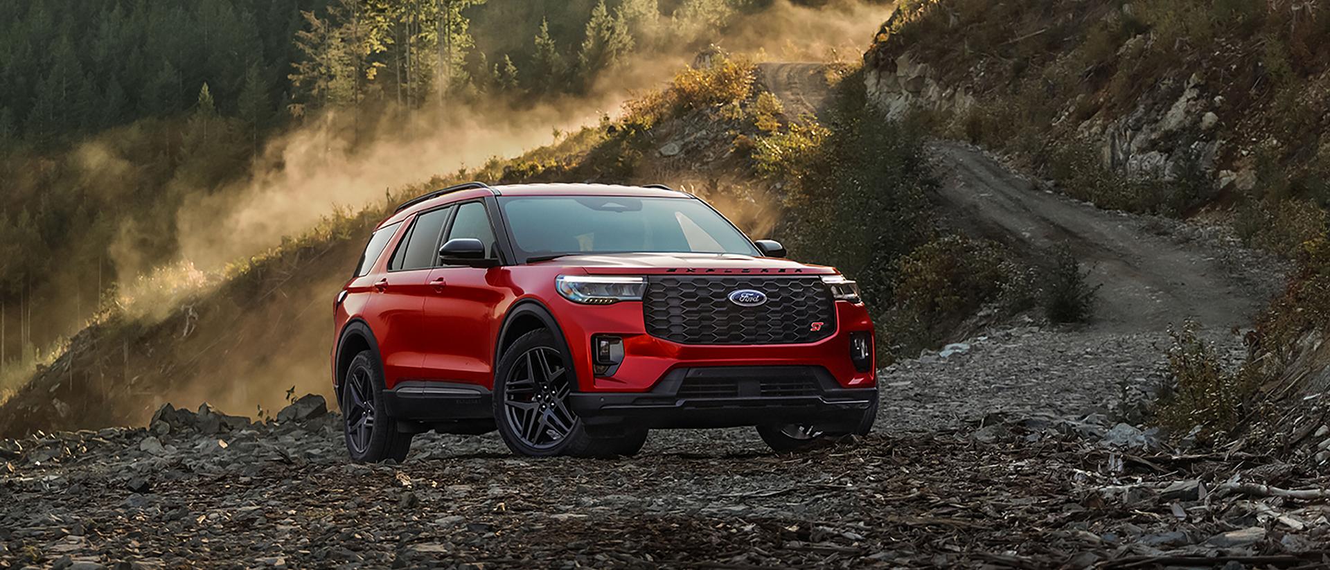 A 2026 Ford Explorer® ST SUV parked on a rocky expanse near a mountain
