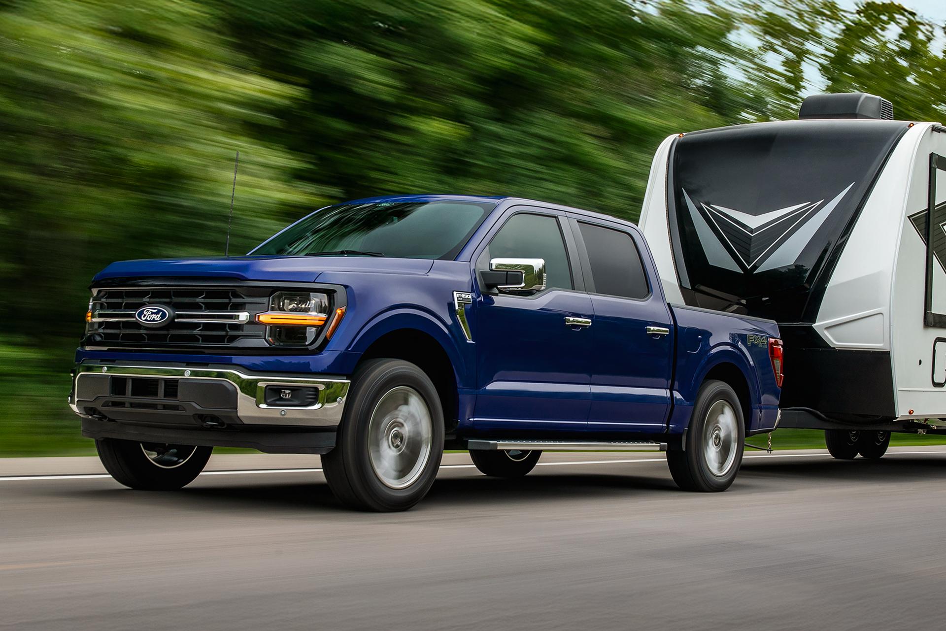 2026 Ford F-150® XL pickup in Atlas Blue Metallic pulling a camper