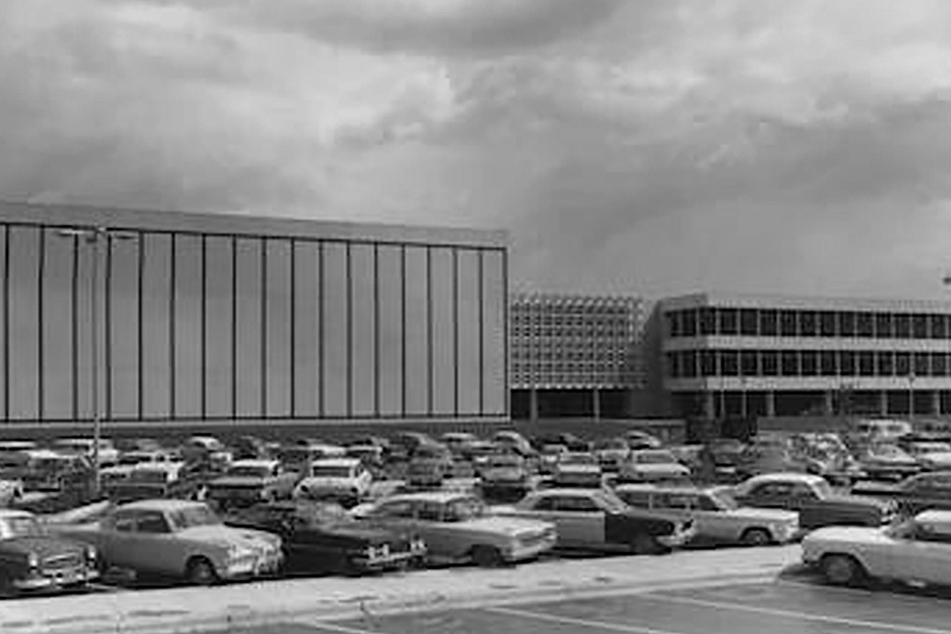 A parking lot full of cars outside of Mission Control Center