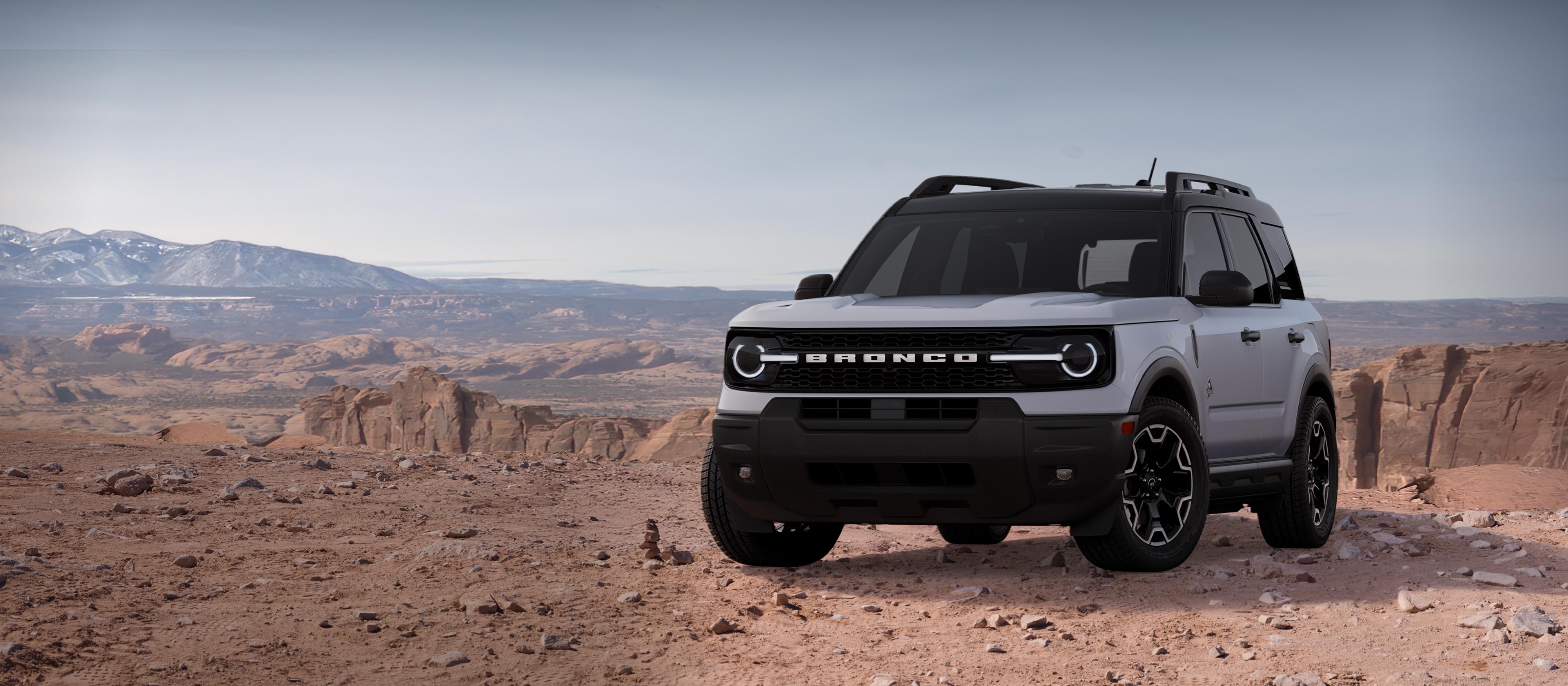 2026 Ford Bronco Sport® Outer Banks® parked on dirt with rocky cliffs in background