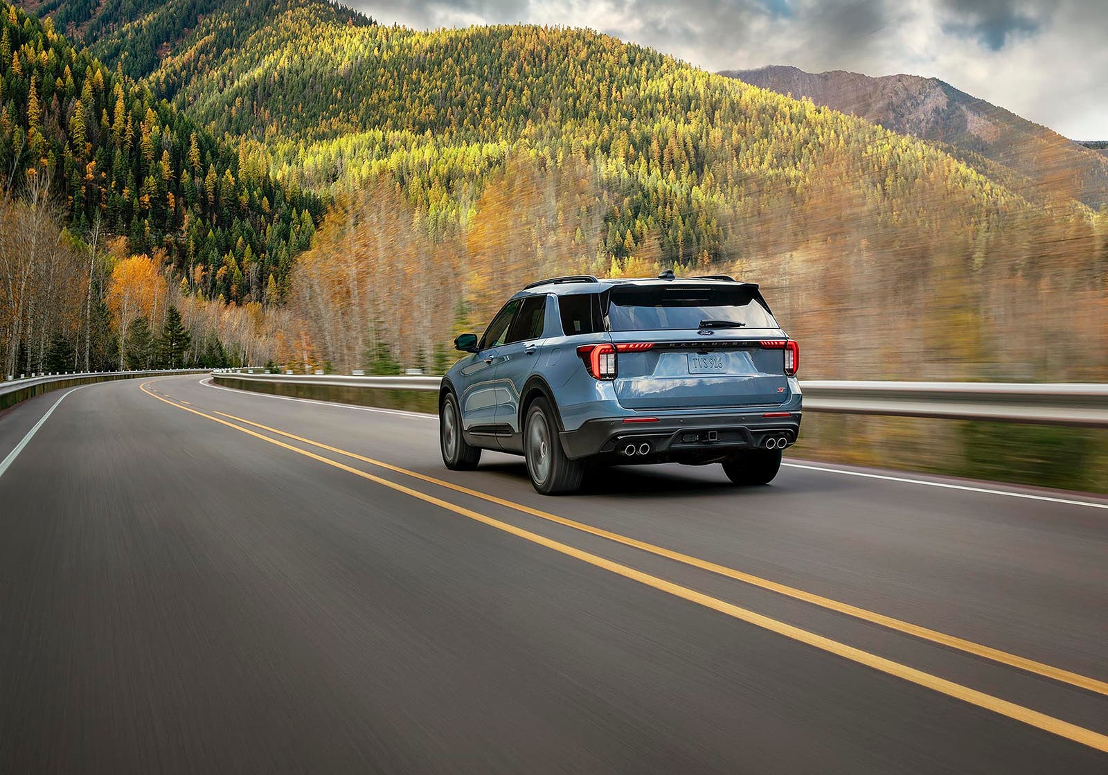 2027 Ford Explorer ST driving through winding hills on a highway