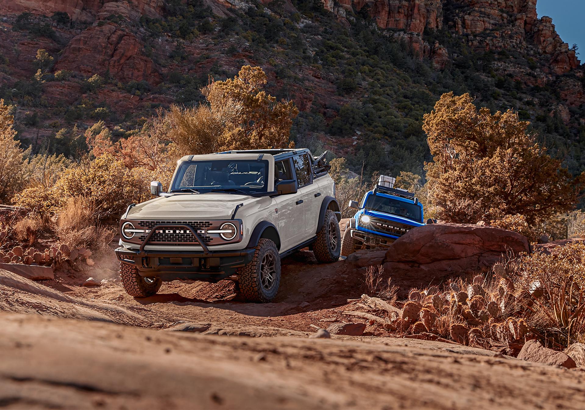 A line of 2026 Ford Bronco® SUVs parked next to each other on a mud flat