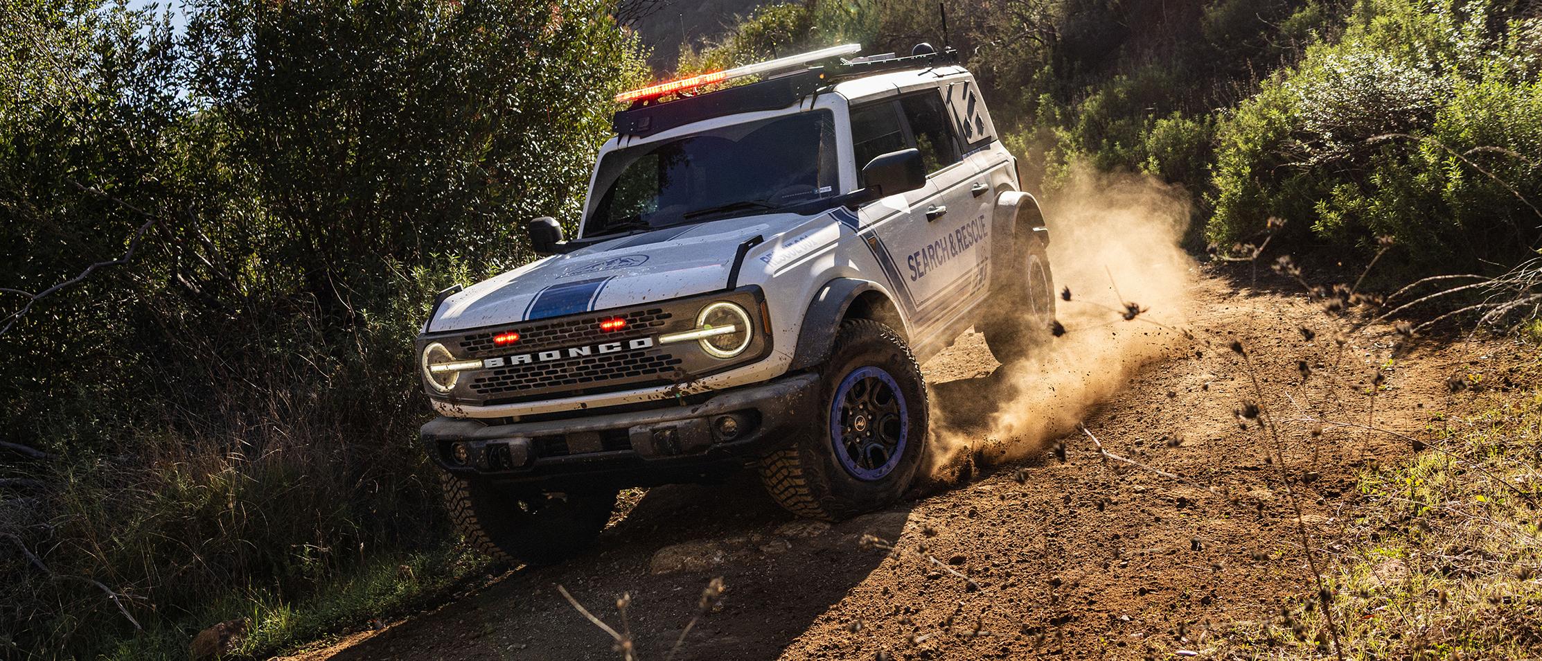 A Ford Bronco Badlands equipped with search and rescue gear driving down a hill