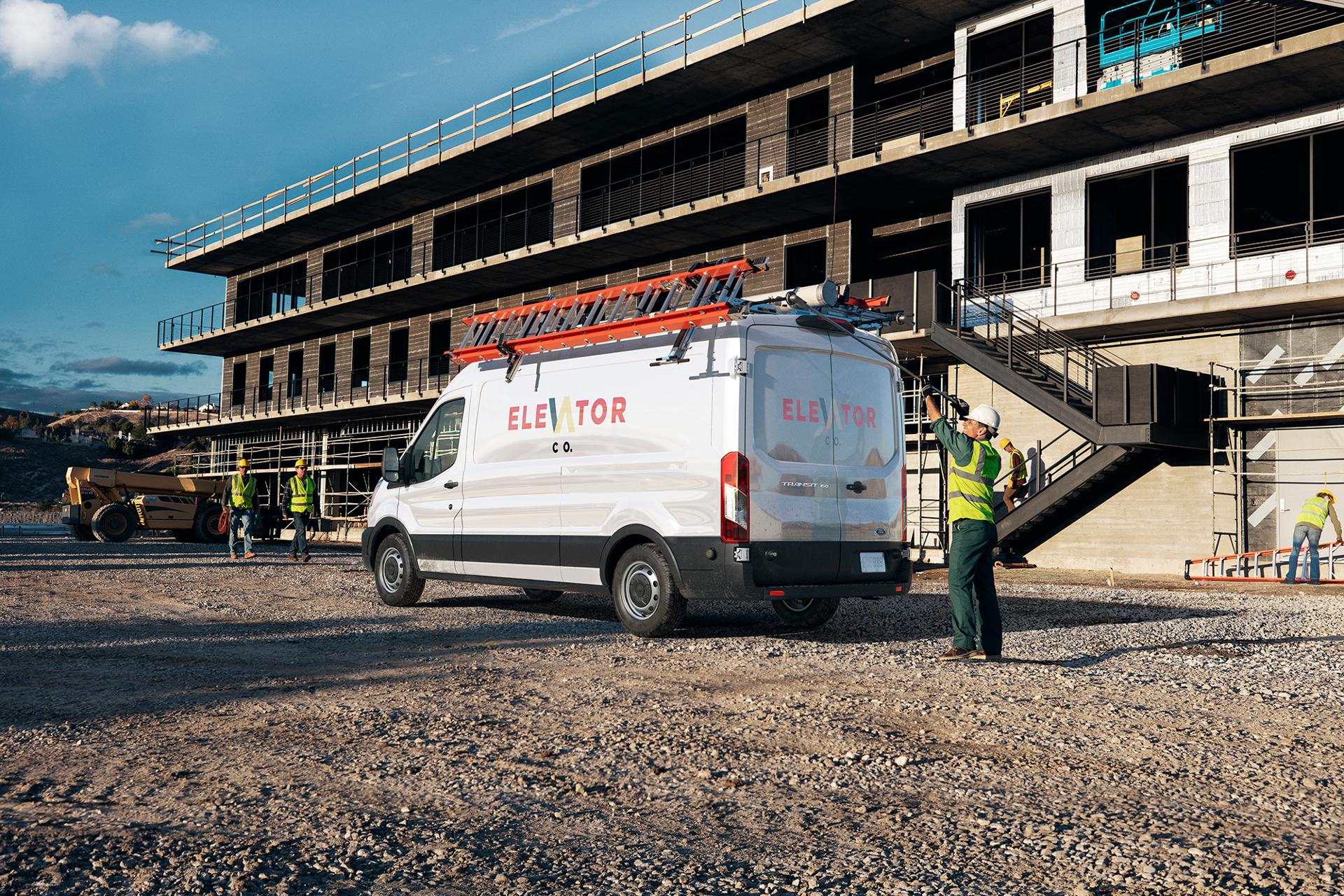 2025 Ford Transit® at a job site with a construction worker behind the van