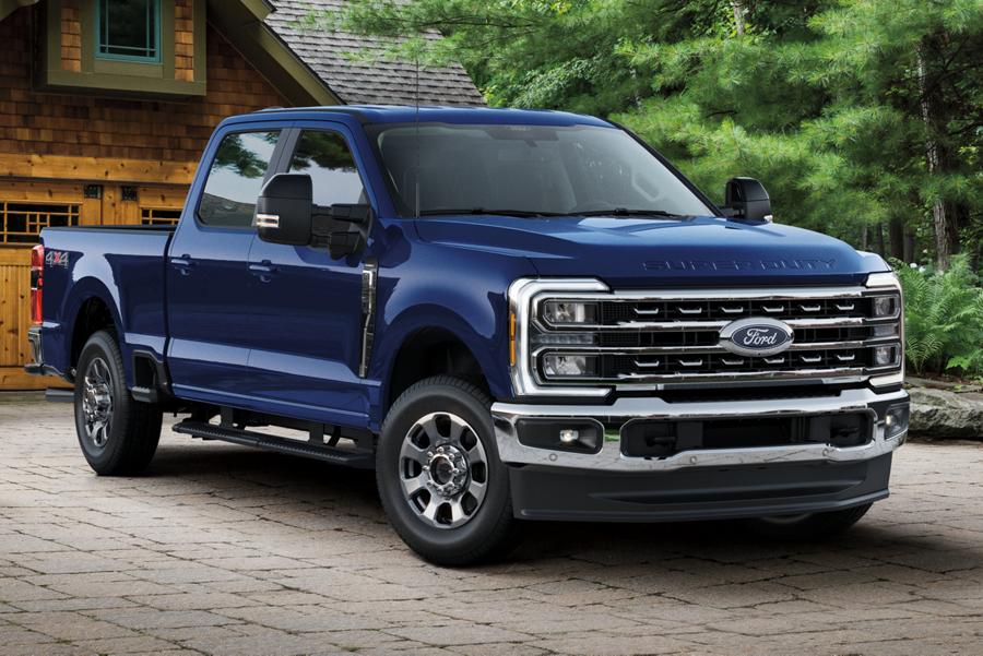 2026 Ford Super Duty® F-350® with the new Lariat® Premium Package parked in front of a house in a wooded area