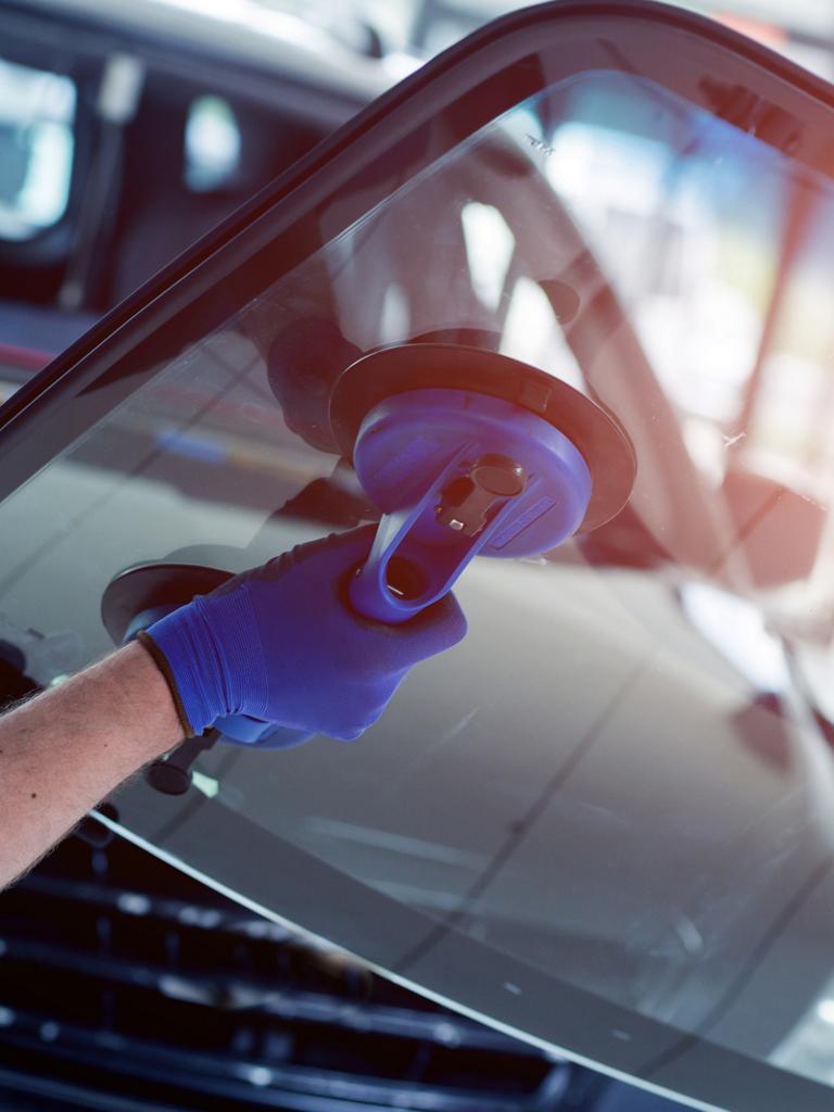 Ford technician installing a windshield