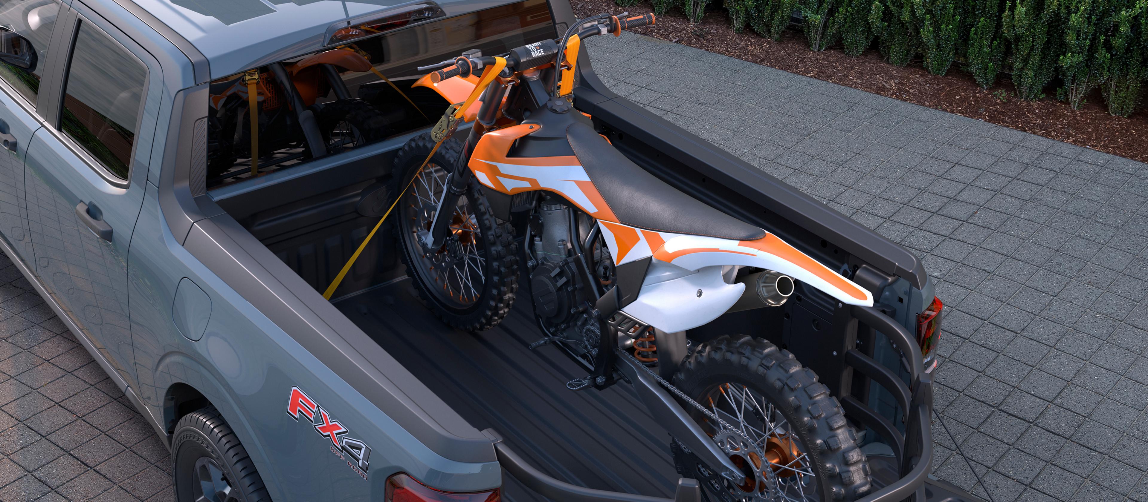 2026 Ford Maverick® Tremor® model shown with optional Ford Accessories with a dirt bike secured in the bed