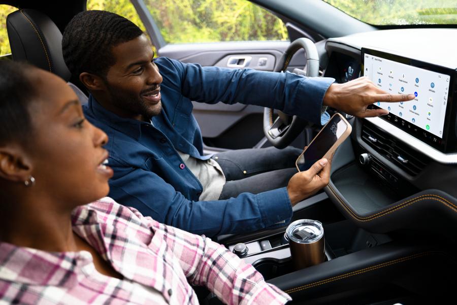 Two people in a 2026 Ford Explorer® SUV with the BlueCruise system active, using the center display
