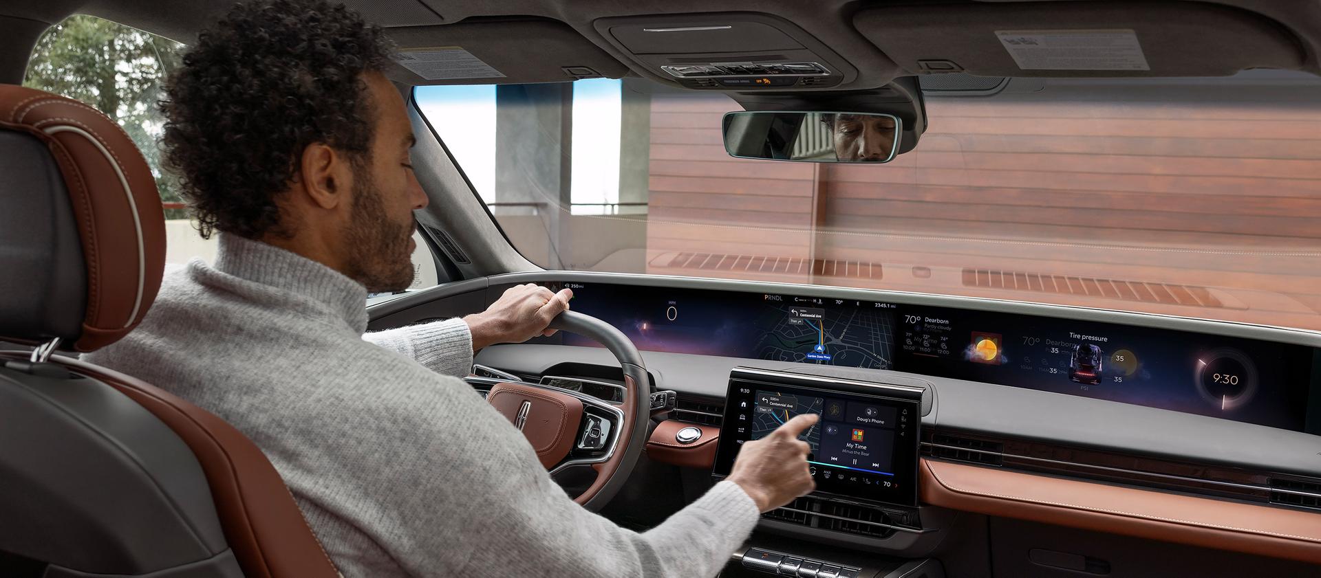 A driver using a vehicle screen