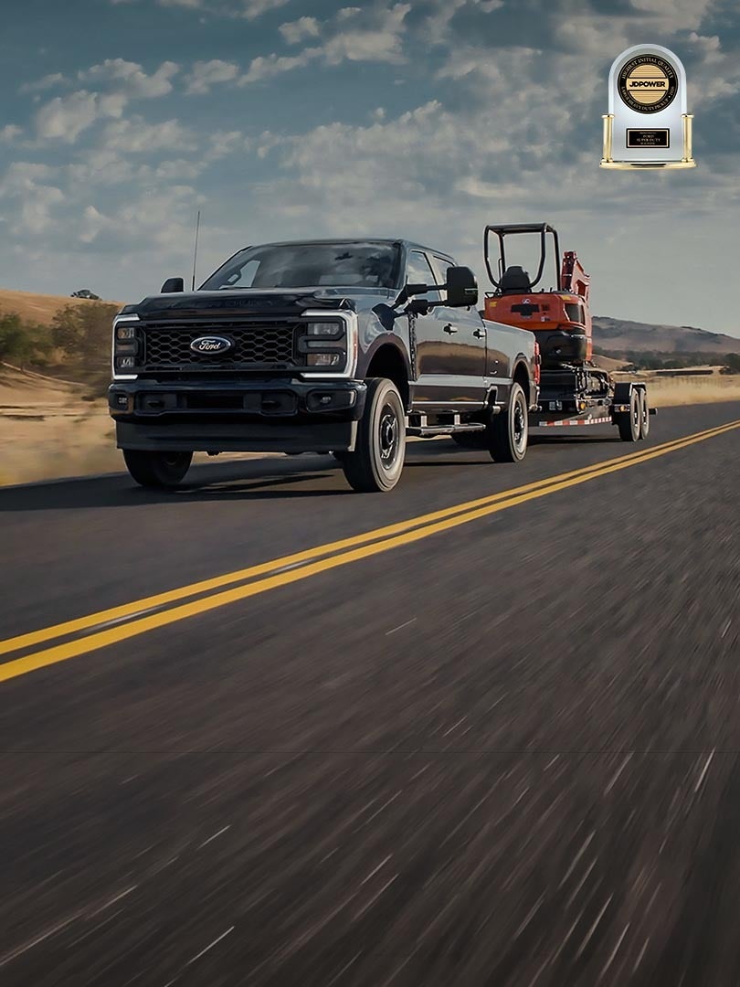 2026 Ford Super Duty® F-250® XL pulling a small trailer on a paved road