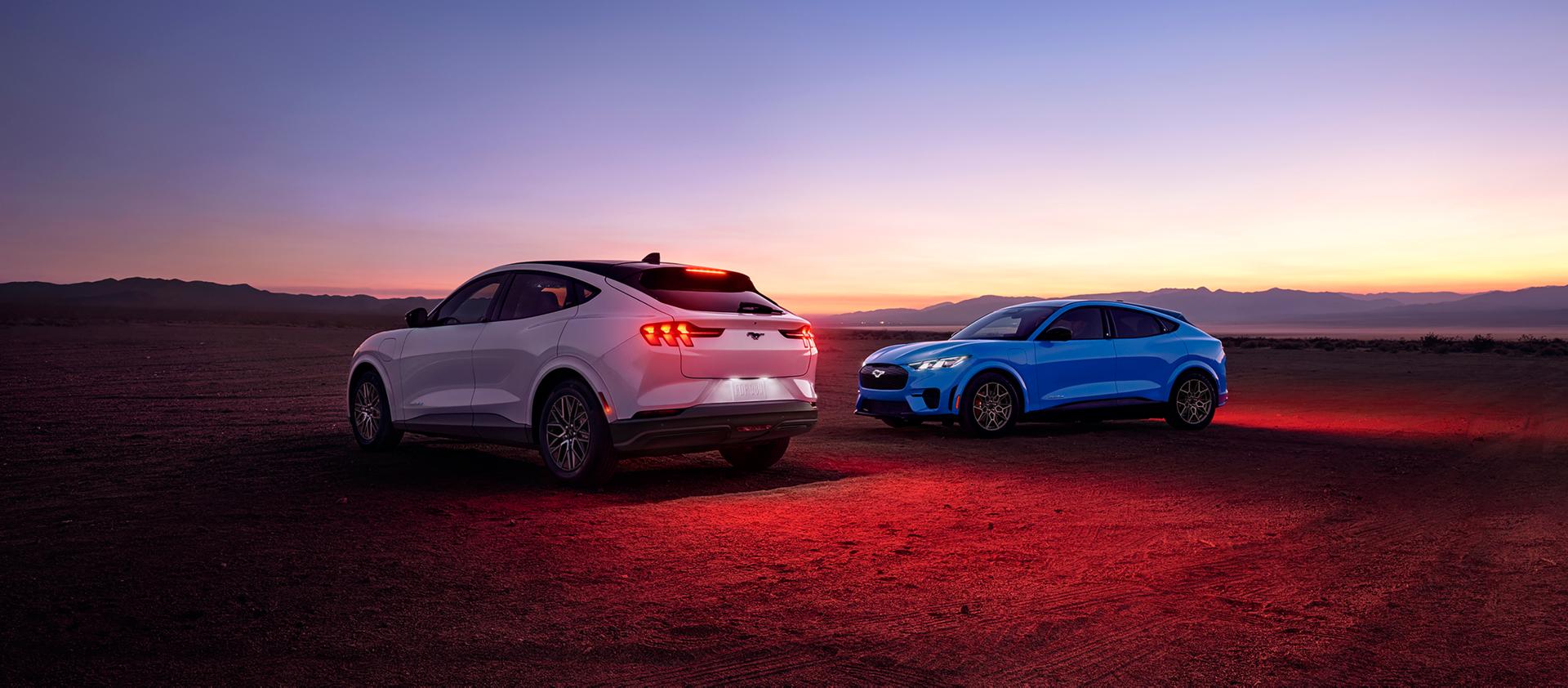 2026 Ford Mustang Mach-E® Premium model (left) and 2026 Ford Mustang Mach-E GT model (right) parked in a desert landscape