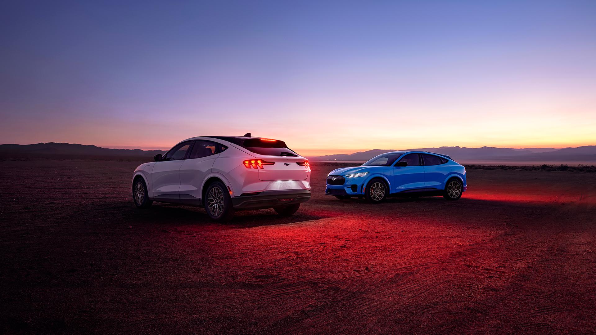 2026 Ford Mustang Mach-E® Premium model (left) and 2026 Ford Mustang Mach-E GT model (right) parked in a desert landscape