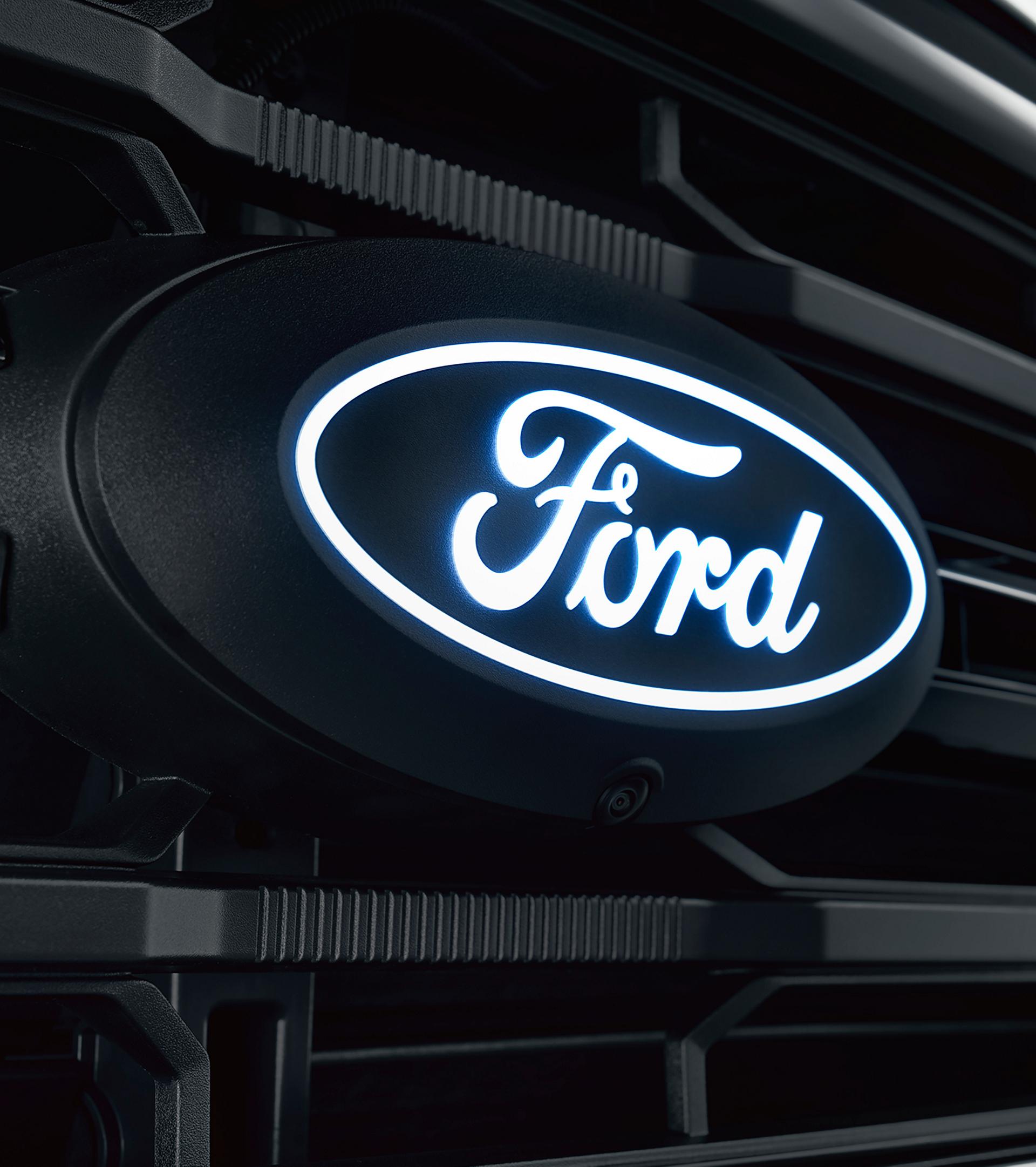 Close-up of the Ford F-150® front grille with the illuminated Ford oval