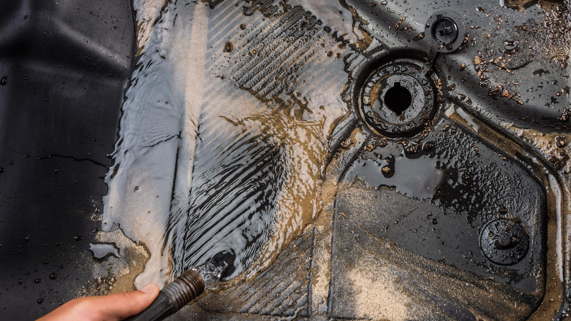 Muddy water running out of the drain plug in the floor mat of a 2026 Ford Bronco® SUV