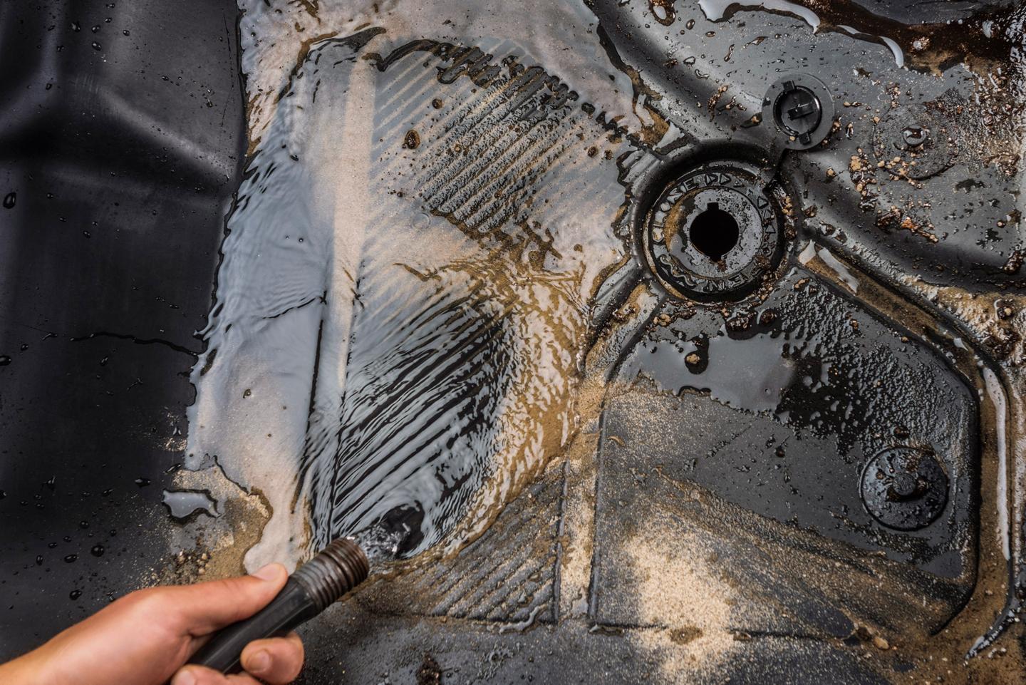 Muddy water running out of the drain plug in the floor mat of a 2026 Ford Bronco® SUV