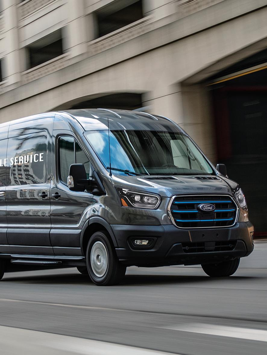 A 2027 Ford E-Transit™ driving down the road