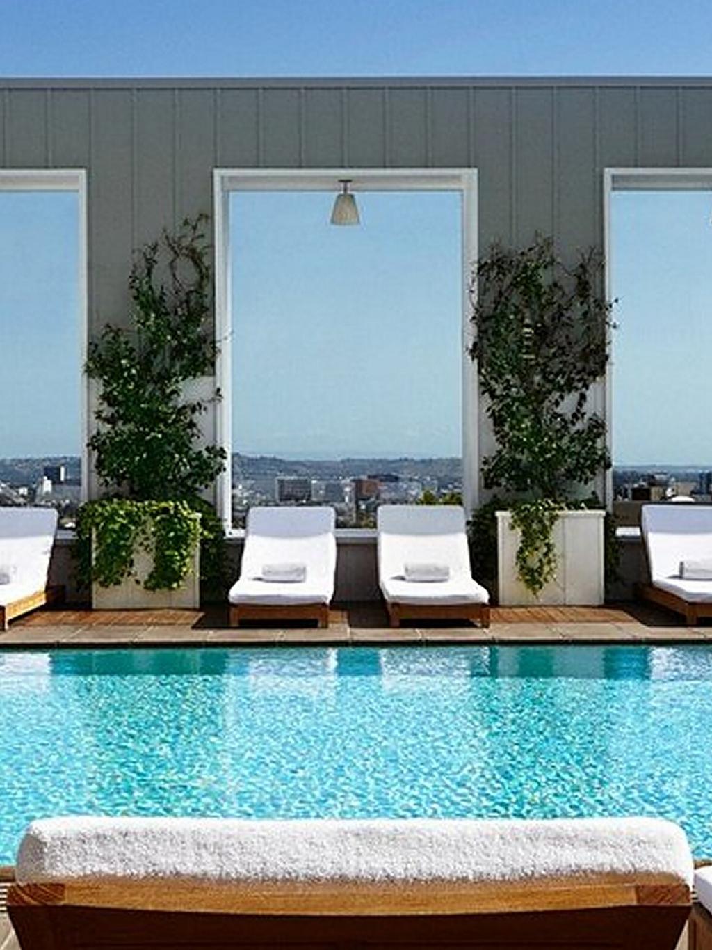 A nice pool side oasis with palm trees.