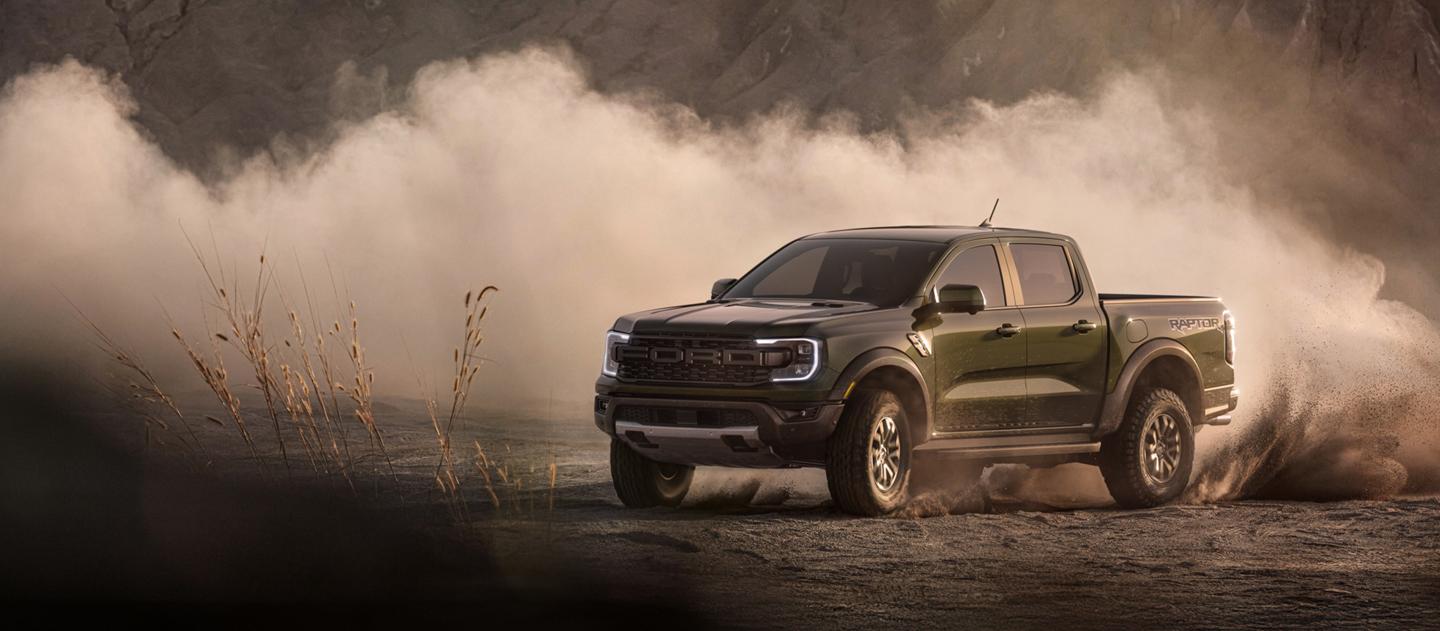 2026 Ford Ranger® Raptor® model kicking up dirt while being driven off-road