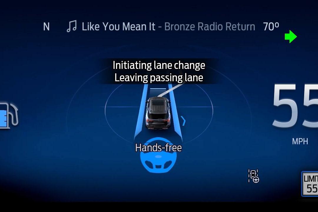 Ford BlueCruise dashboard showing initiating lane change and slower vehicle ahead notifications