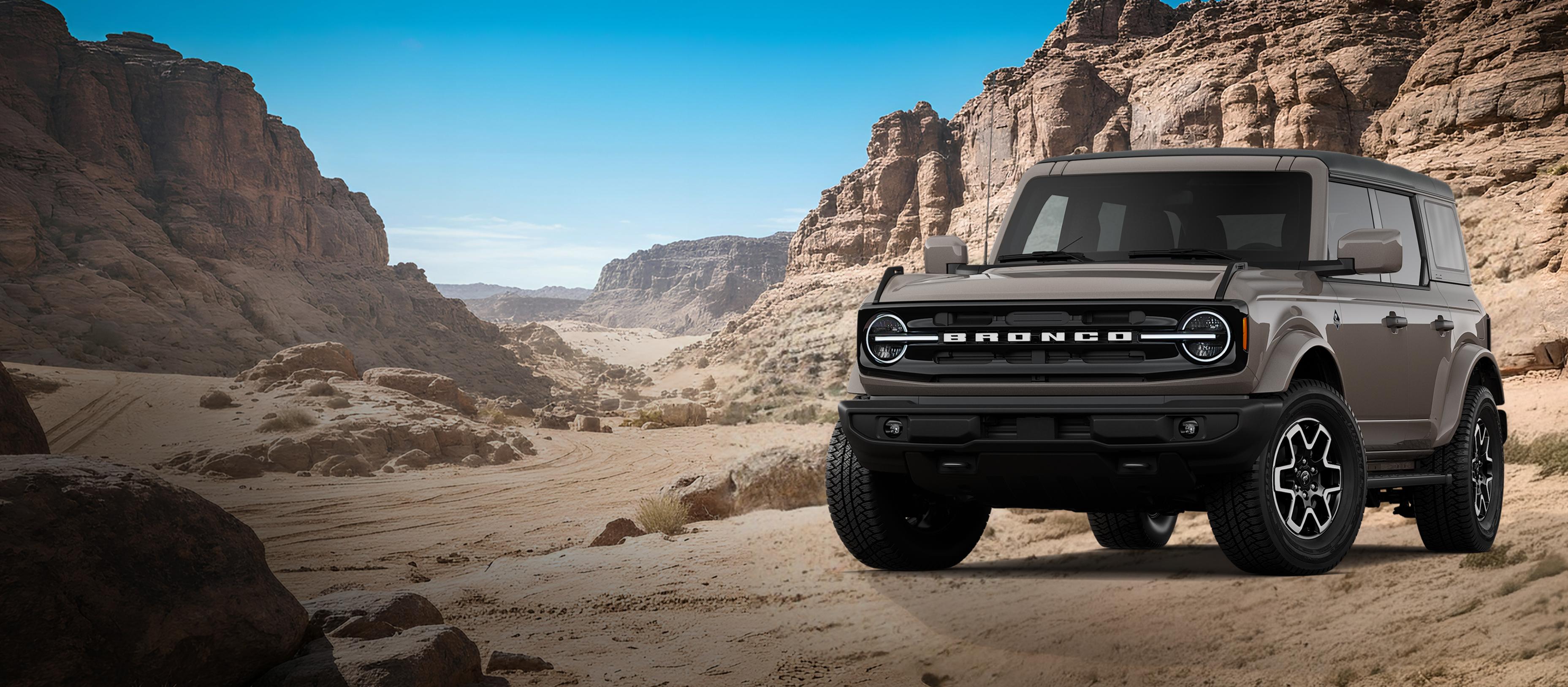 A 2026 Ford Bronco® Outer Banks model shown in Marsh Gray parked on a rocky expanse