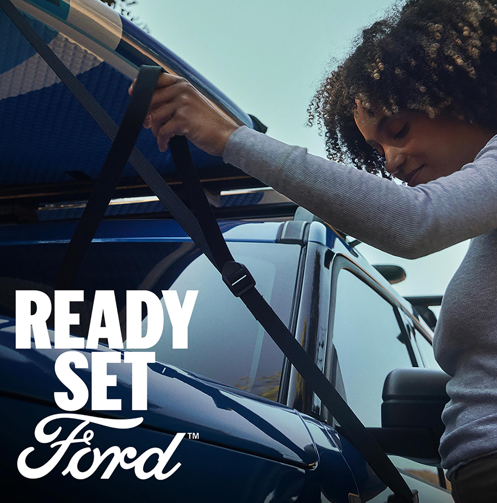A person securing a kayak to the roof of a 2026 Ford Bronco Sport® SUV