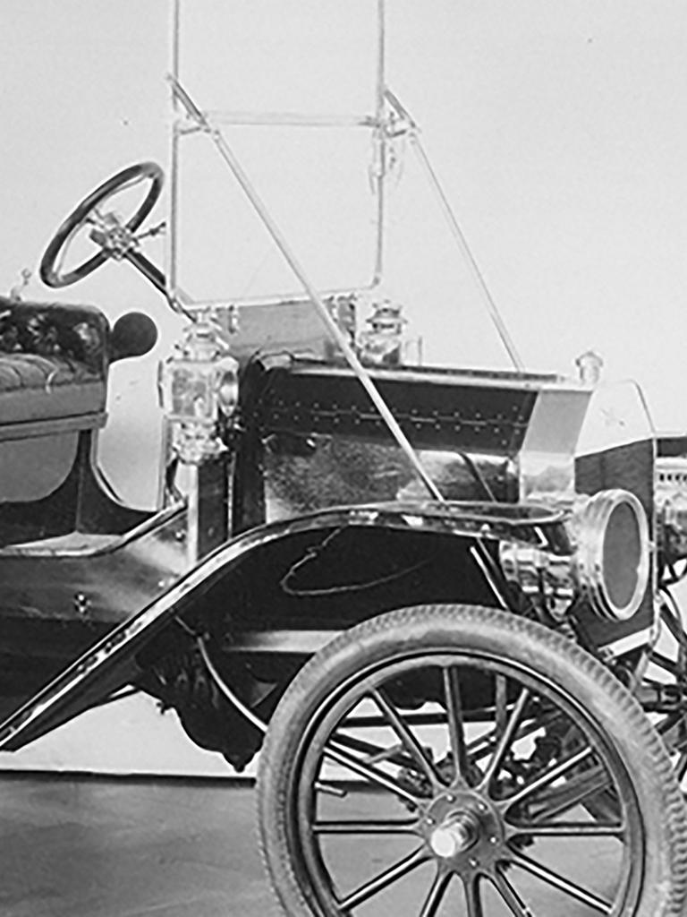 A black and white photo of a Ford Model T car