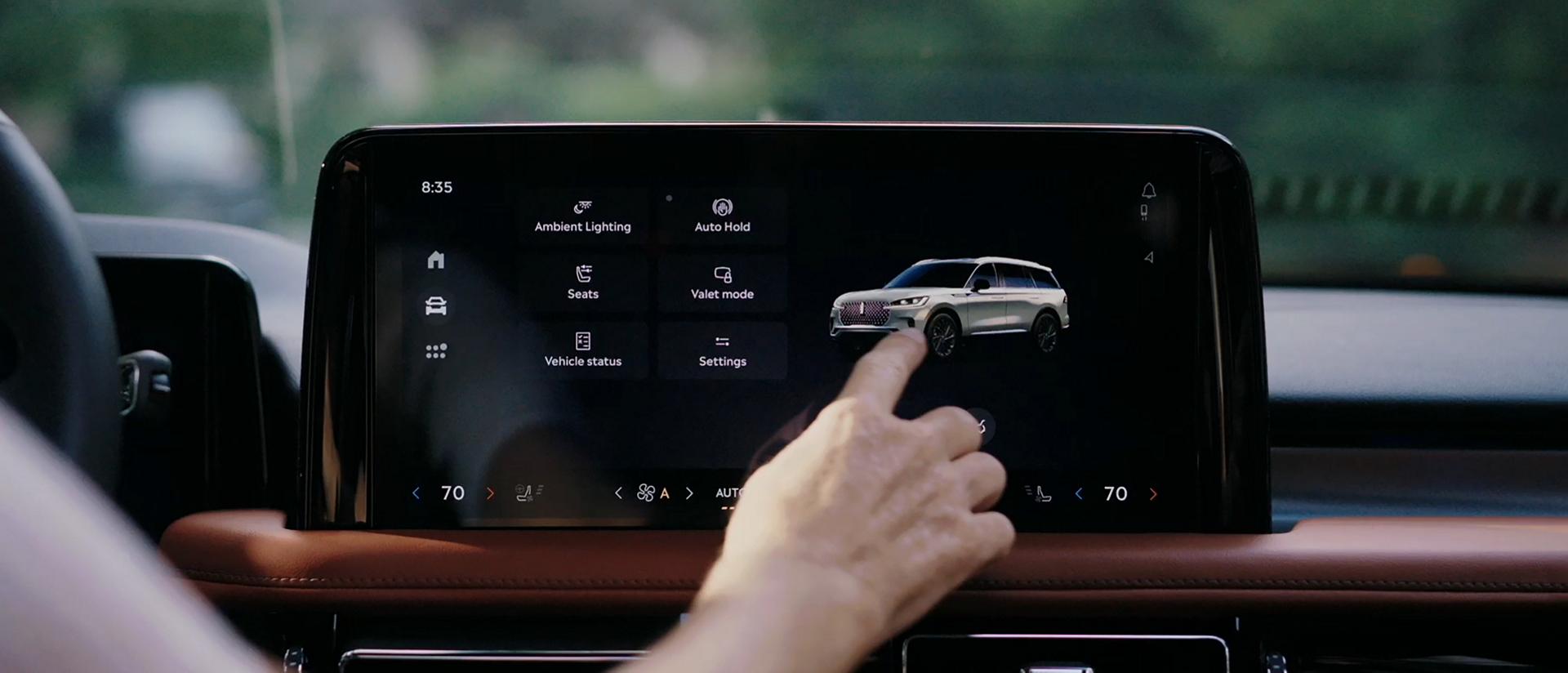 A person interacts with the centre touchscreen of a 2026 Lincoln Aviator