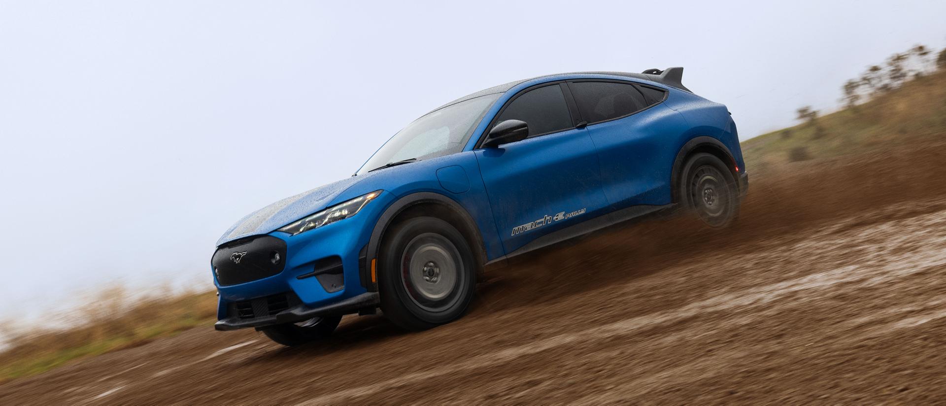 The Ford Mustang Mach-E® Rally SUV rips along a mud track 