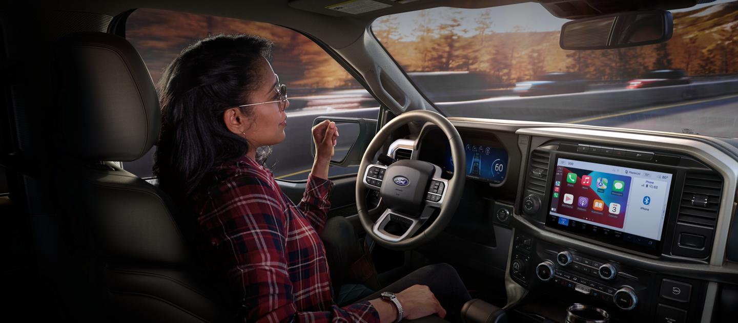 Woman drives a Ford vehicle hands-free.