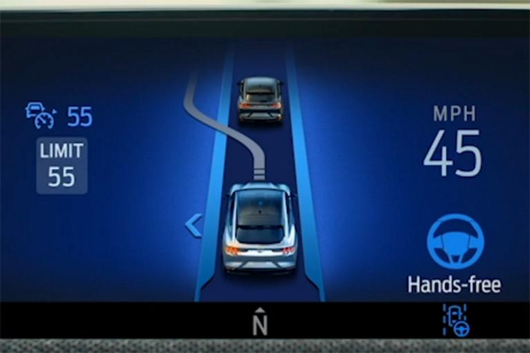 Ford BlueCruise dashboard showing "Initiating lane change. Slower vehicle ahead” notification