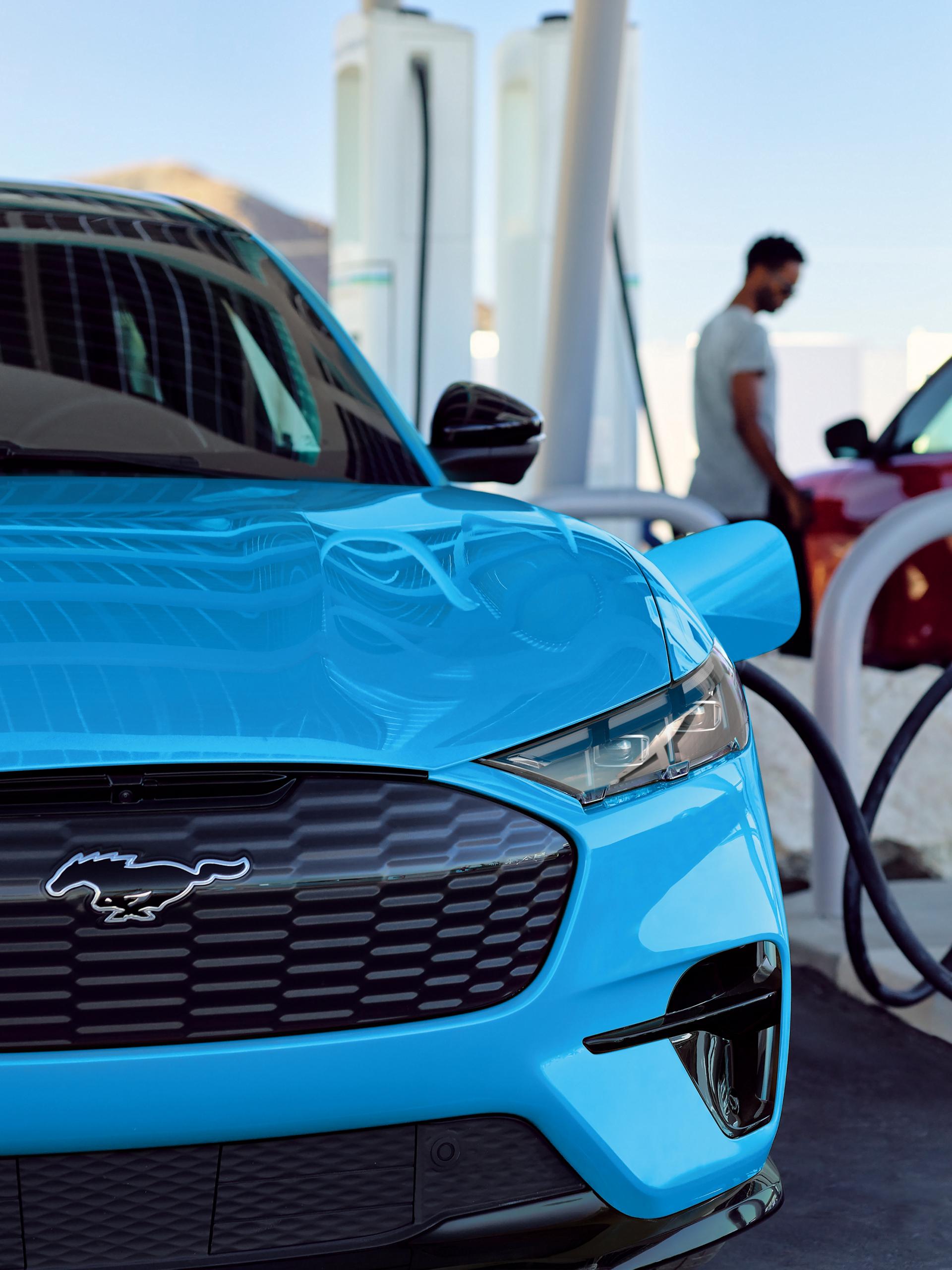 A couple of Ford vehicles are charging at a public charging station