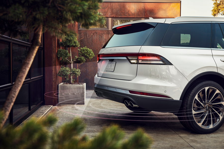 Simulated radar waves are shown coming from the rear of a Lincoln Aviator