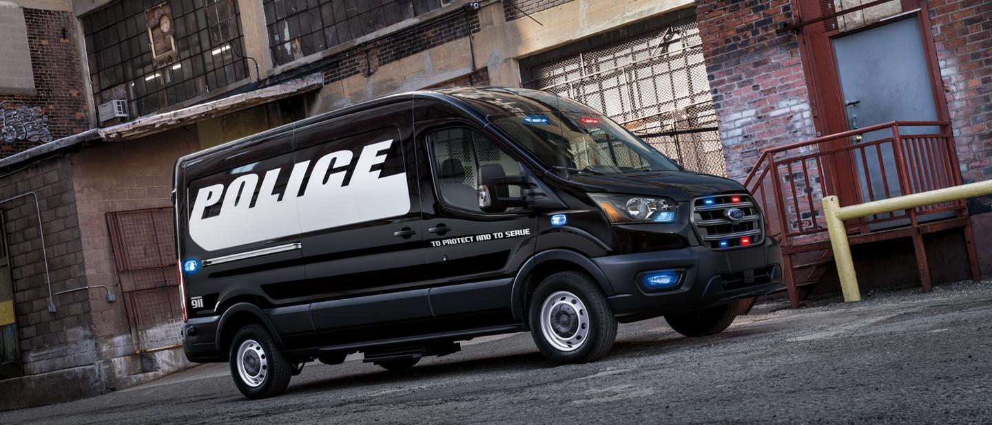 The twenty twenty ford transit prisoner transport vehicle parked in an alley