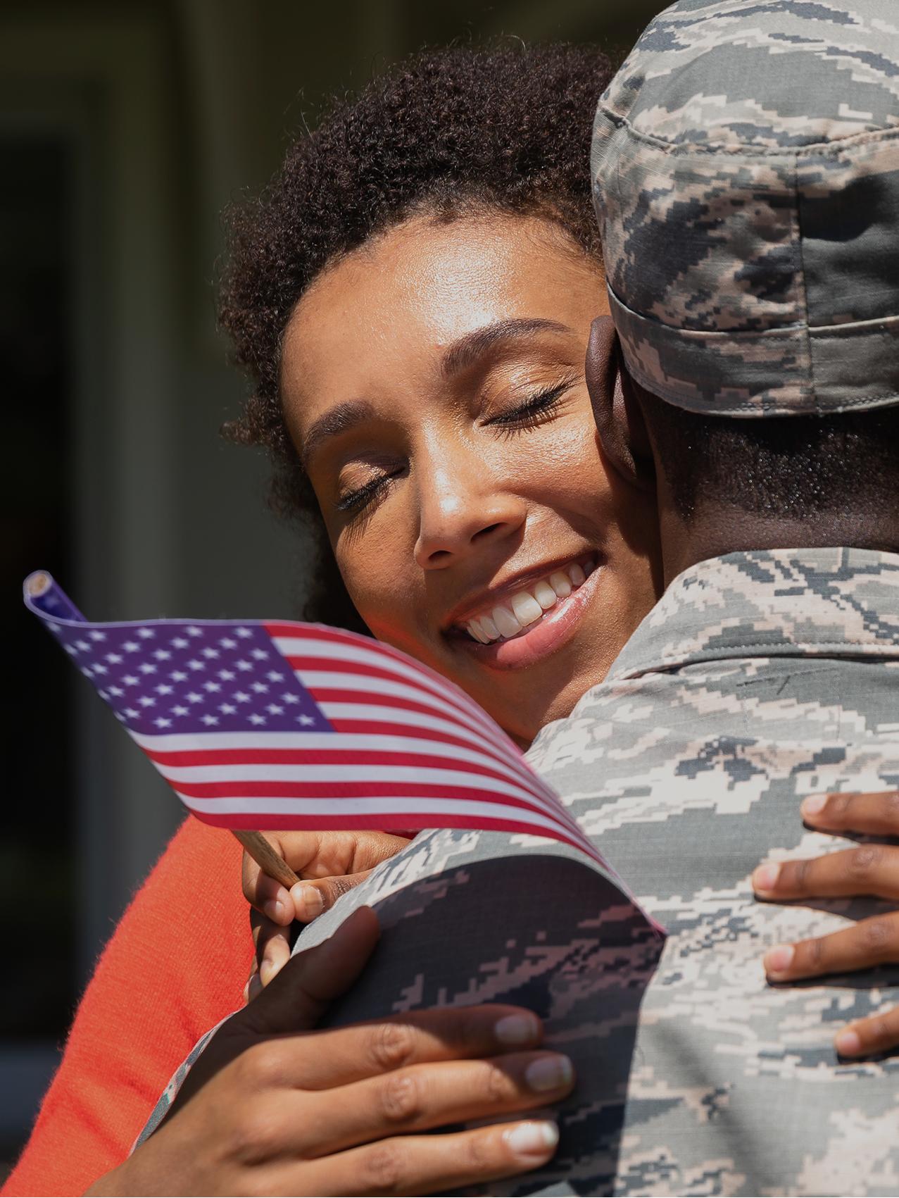 A service member is welcomed home by their family