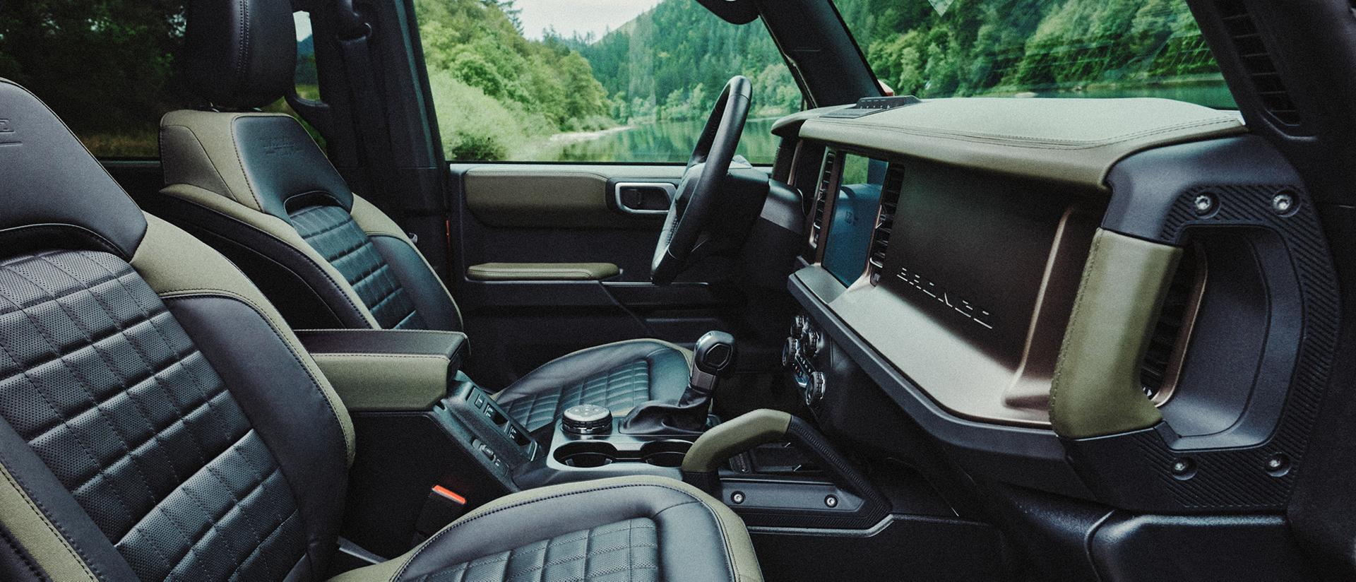 The front-row seats and dashboard inside a 2027 Ford Bronco® Filson™ SUV