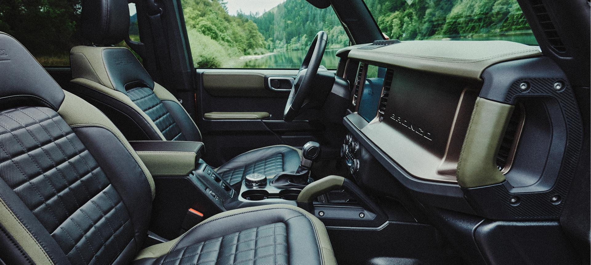 The front-row seats and dashboard inside a 2027 Ford Bronco® Filson™ SUV