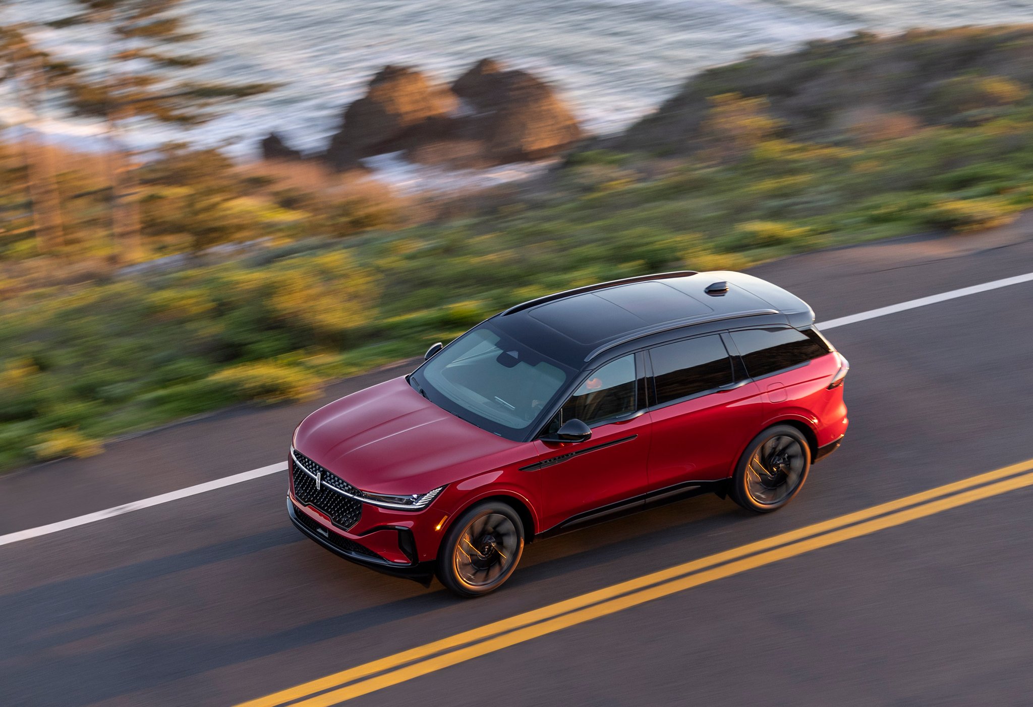 A 2025 Lincoln Nautilus SUV is being driven with the painted black roof showing prominently