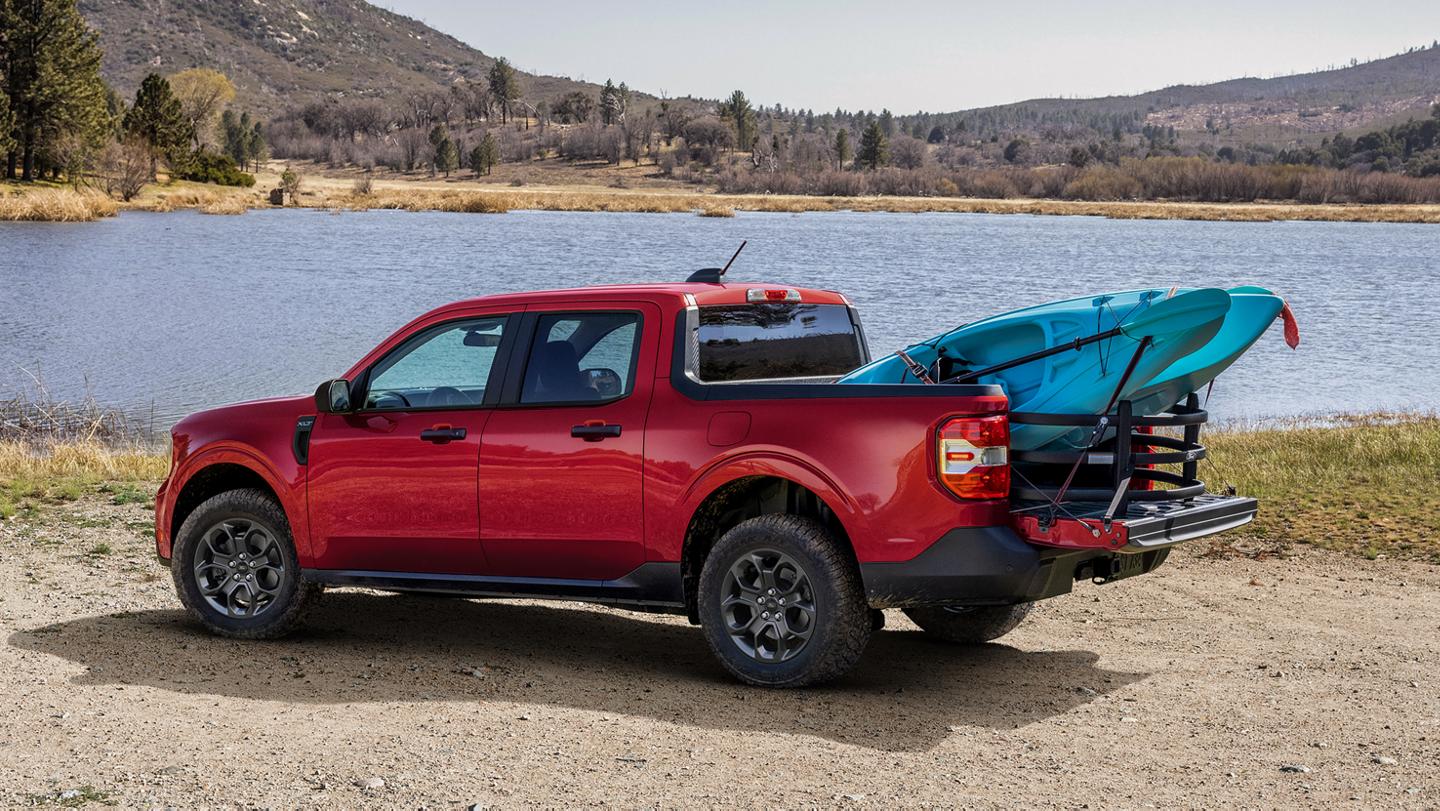 2026 Ford Maverick® Lariat® parked near a lake with two kayaks in the bed. Optional equipment shown.