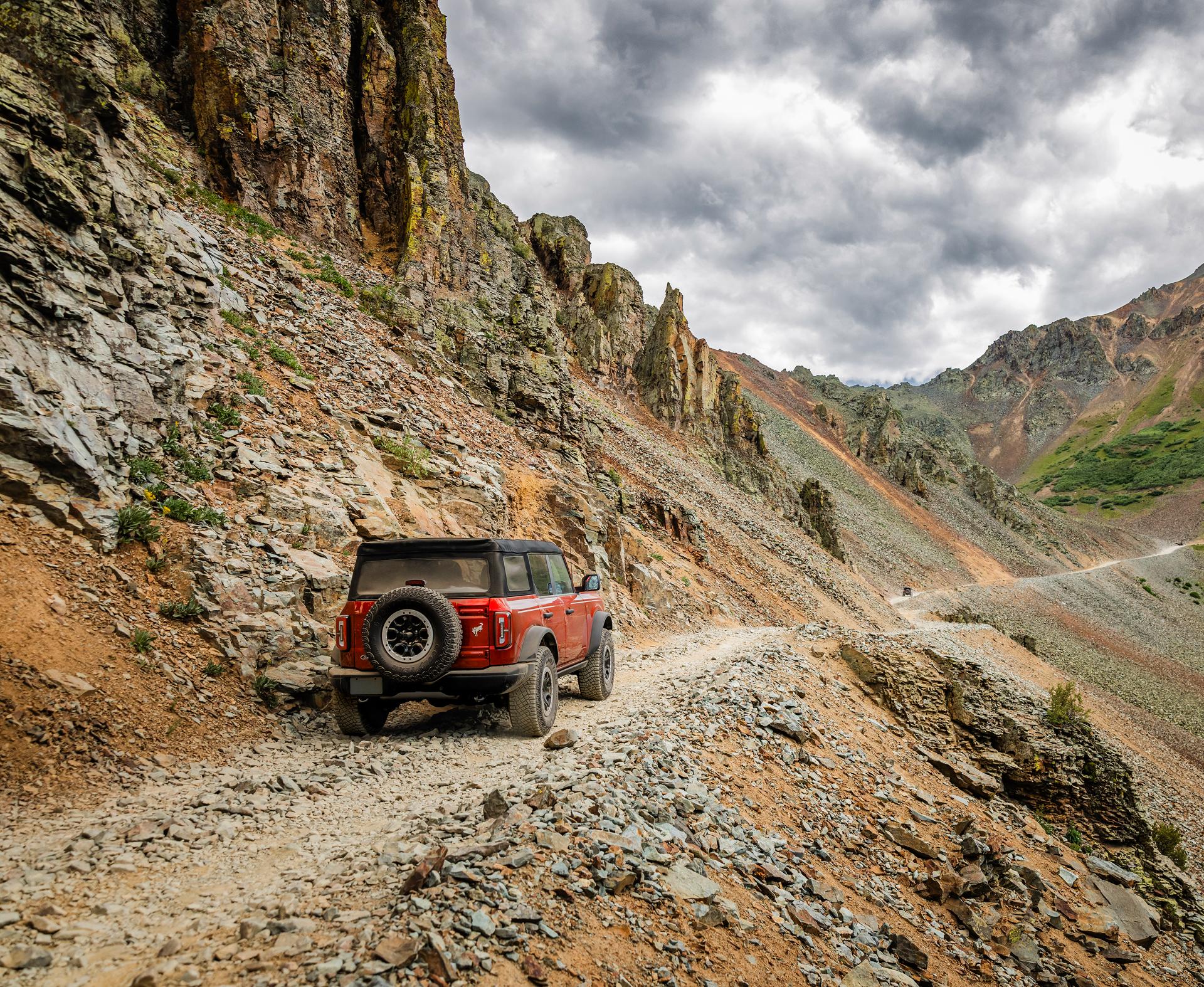 Ford Bronco® SUV being driven along a rocky road through mountains