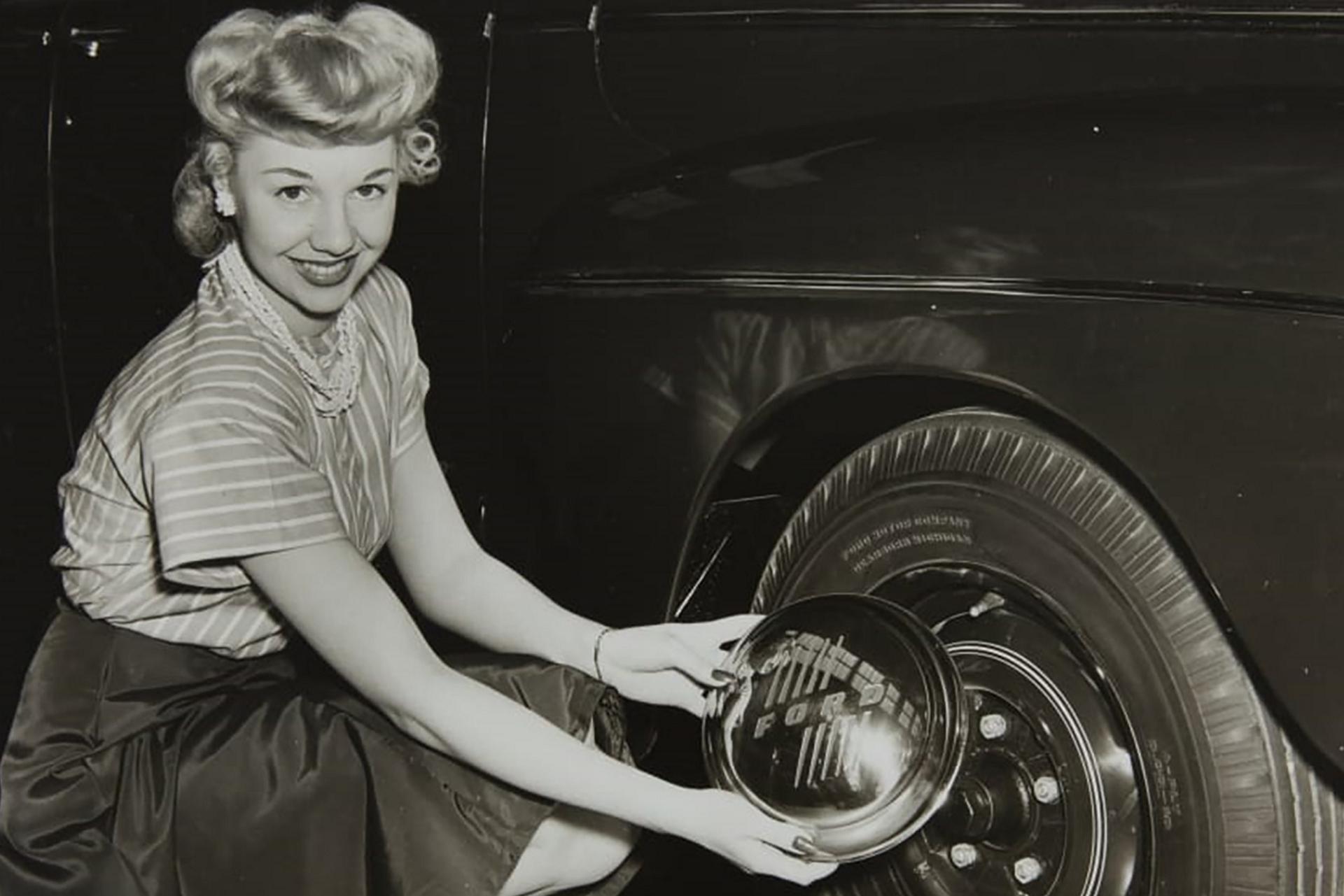 An image of Leota Carroll with a 1945 Ford Sedan hubcap 