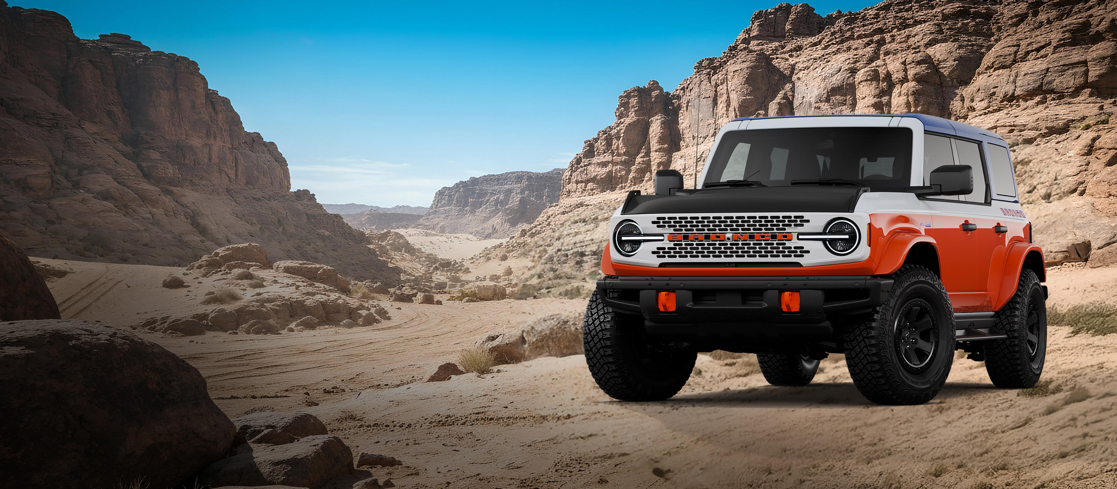 A 2026 Ford Bronco® Stroppe model shown in Oxford White parked on a rocky expanse