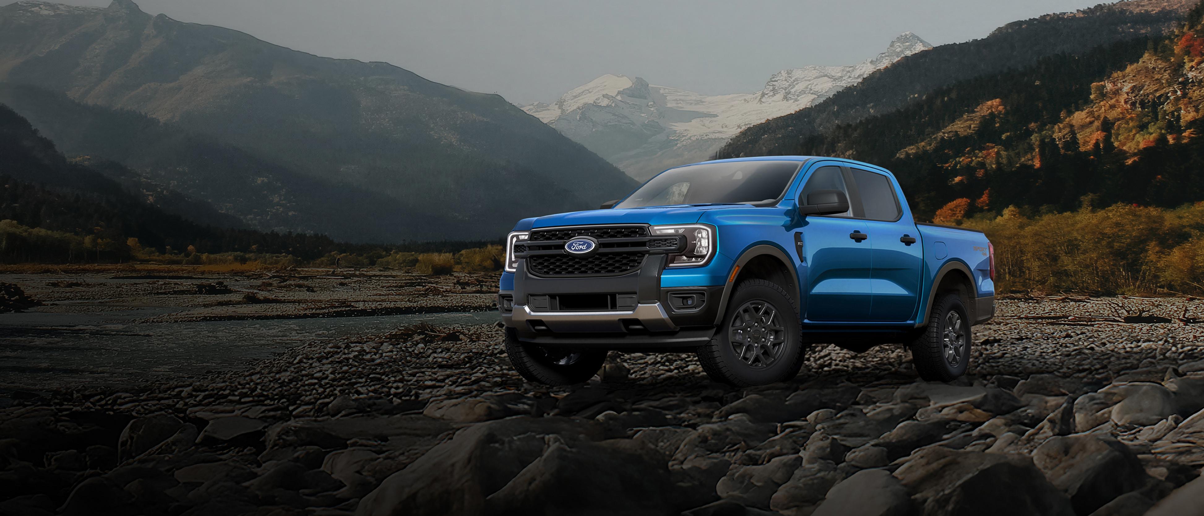 A 2026 Ford Ranger® XLT model parked on a rocky river bank in the mountains
